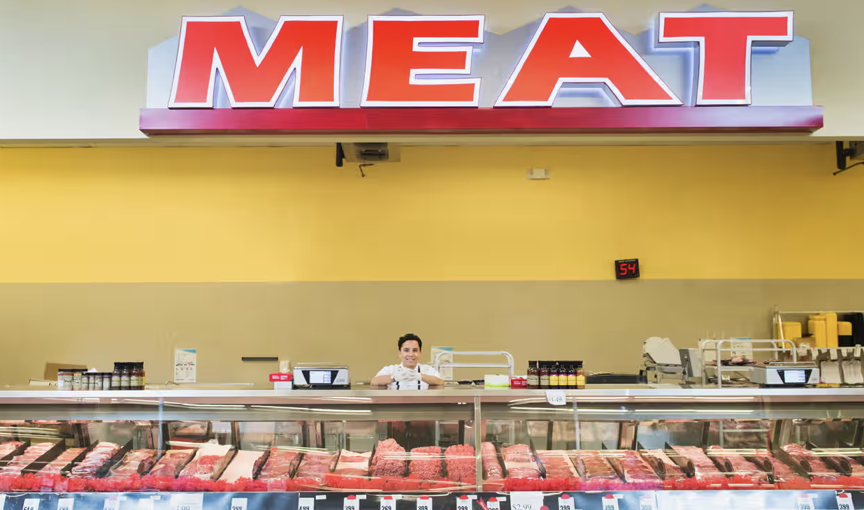 meat counter in a store with giant 'meat' sign